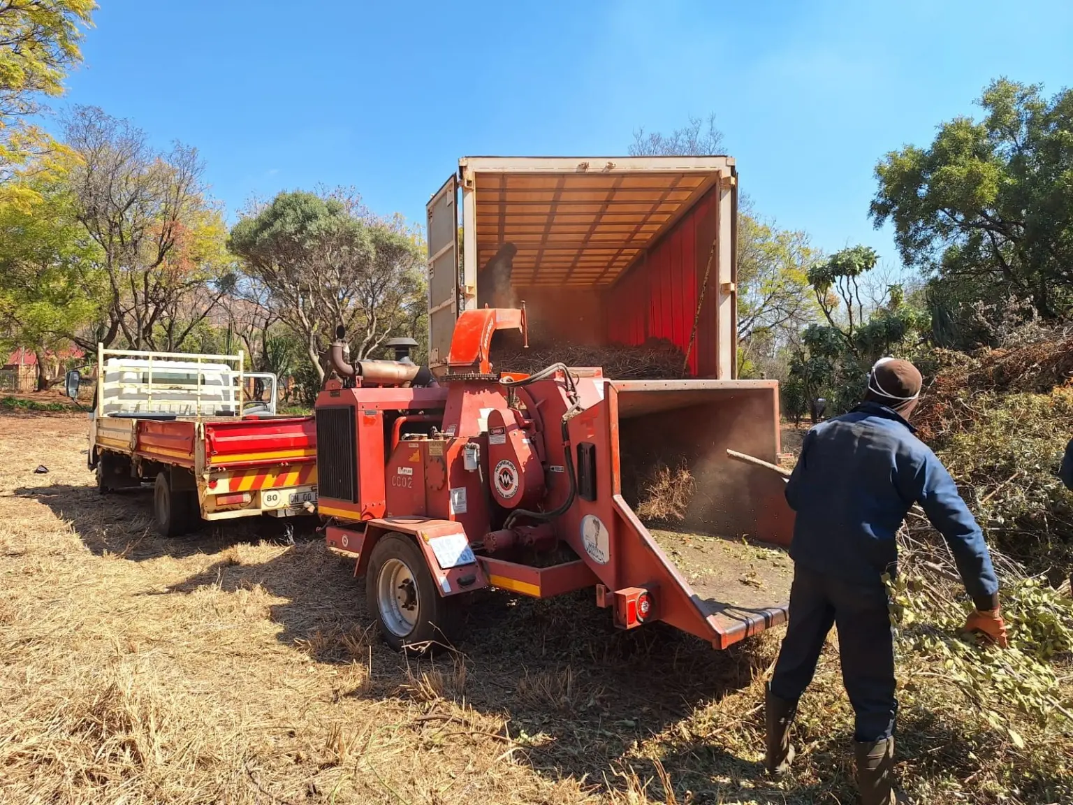 ChipperMan crew loading chips into a container truck